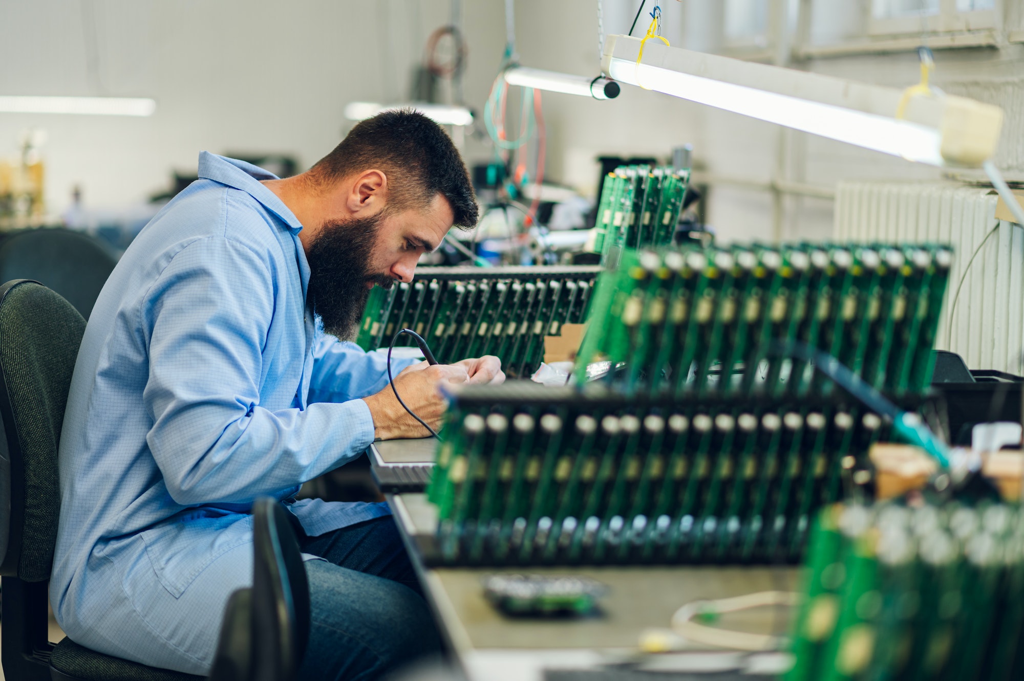 Electronics engineer working in a workshop with tin soldering parts